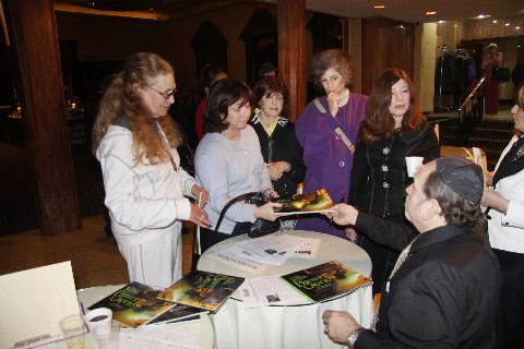 Chris Nicola autographing his book for Ms. Abend, Dena Lenefsky, Rebbitsen Tsipporah Rimler, Elaine Weinberg, & Raya Zegel